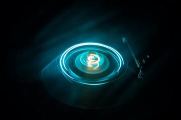 Music Dj concept. Trail of fire and smoke on vinyl record. Burning vinyl disk. Turntable vinyl record play Selective focus