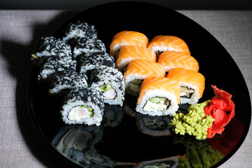 Japanese cuisine, professional culinary, seafood, restaurant menu, food photo art. Delicious sushi rolls set served on plate, copy space. High quality photo