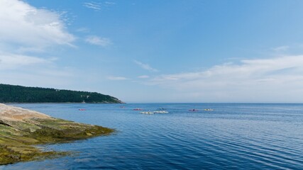 Fototapeta na wymiar Kayaks on the ocean getting in the bay on a sunny day