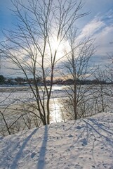 Fototapeta na wymiar Winter scene with steaming frozen river on a cold sunny day