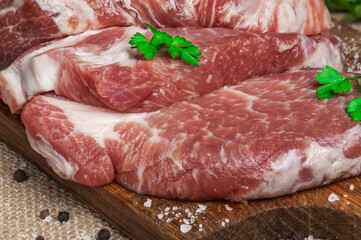 Raw fresh meat. Raw pork steak on a wooden board.
