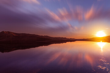 Fototapeta na wymiar Beautiful sunset over the lake with reflection . Panoramic sunset landscape.