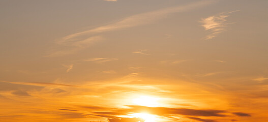 Beautiful bright orange sunset sky with dramatic clouds. Sunset sky with clouds background.