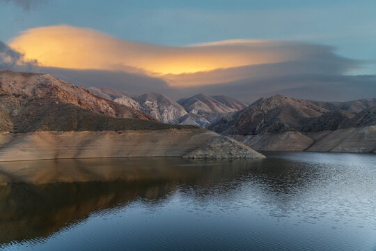 Beautiful sunset over the mountains and lake. Beautiful reflection in the water. © Inga Av