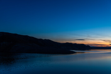 Beautiful sunset over the lake. Panoramic sunset landscape.