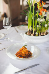 Traditional Italian pasta with tomatoes, basil and parmesan. Restaurant table setting.