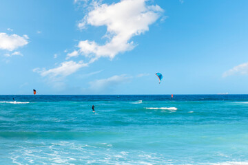 Enjoying extreme windsurfing and ocean waves on the hot sunny day