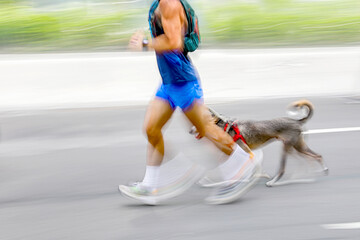 runner with dog on the street