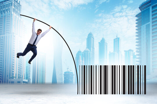 Businessman jumping over bar code in pole vaulting