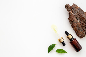 Medical herbs oil on dropper bottle. Herbal serum or essential oil