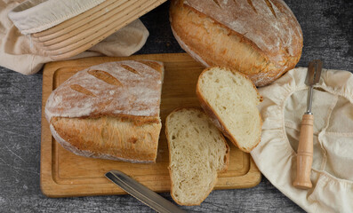 Crusty bread sliced on rustic background with bannetone