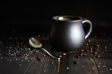 A cup of delicious morning coffee. Dark arrangement