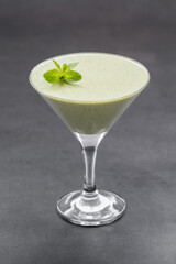 Mint Panna Cotta in a martini glass. Dark gray background