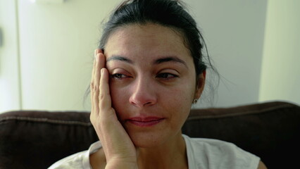 Portrait of a troubled woman crying in despair during hard times. Closeup face of a person feeling anxiety and hopelessness. Real authentic emotion