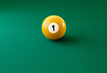 Billiard ball number one isolated on the green table. Photo with copy space symbolizing leadership.