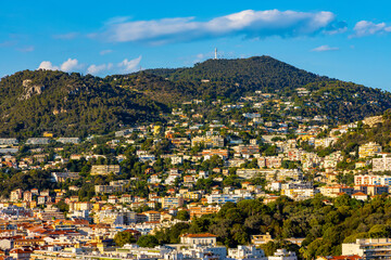Nice sunset panorama with Riquier, Cimiez and Saint Roch historic old town districts with Alpes mountains at French Riviera of Mediterranean Sea in France