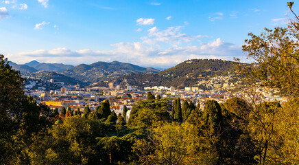 Nice sunset panorama with Riquier, Cimiez and Saint Roch historic old town districts with Alpes mountains at French Riviera of Mediterranean Sea in France