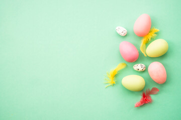 Easter eggs at green background. Flat lay image with copy space.