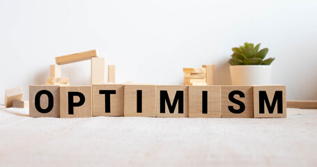 Optimism Word Written In Wooden Cube, concept