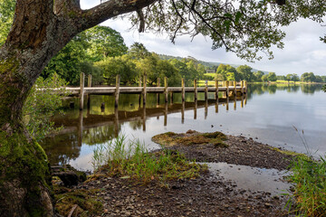 Fototapeta na wymiar A lovely wooden jetty at Monk Coniston, located on the north shore of Coniston Water in the Lake District National Park.