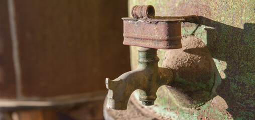 Rusty faucet detail from old olive oil drum