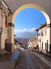 Peru Cuzco city scenic cityscape through ancient arch, street in the old town,