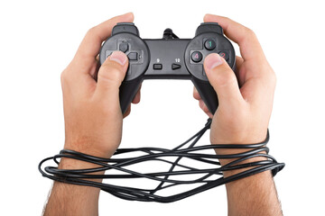 Male wired hands with joypad meaning videogame addiction