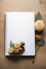 blank notebook standing on an open ground surrounded by flowers