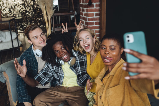 Cheerful group of diverse best friends taking selfie. Young people internation students have fun together, party, celebrate. African American, Caucasian multi cultural college university community