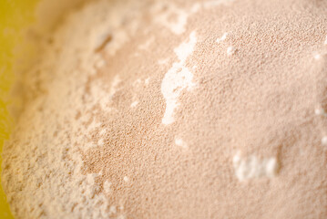 Flour and dry yeast. Preparation for preparation of dough for bread or pizza. Stirring fast-acting granillated yeast with sifted flour.