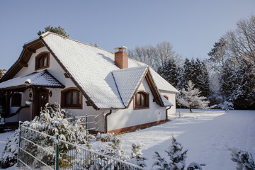 beautiful farmhouse in Germany, in winter. White old farmhouse covered in snow. House with a large...