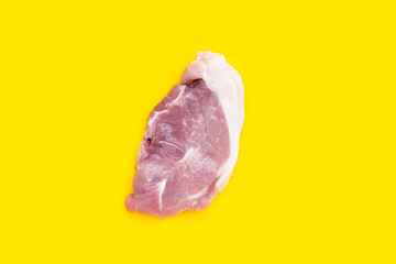 Pork meat on yellow background.
