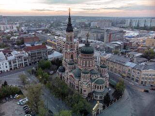 Holy Annunciation Cathedral aerial view with sunset golden cloudscape. Kharkiv city orthodox church in downtown, Ukraine