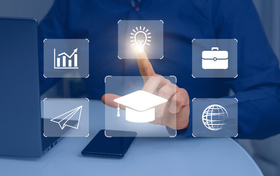 Icons of online education, planet, airplane and idea on background of laptop and hands of businessman. Man in blue shirt uses computer to study lessons on Internet, concept of e-learning