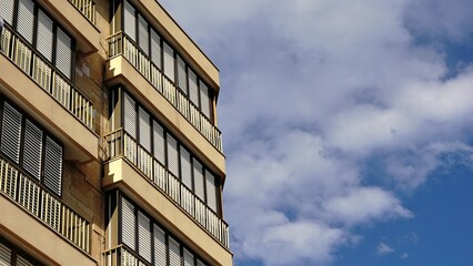 building facade with blinds closed against the sky