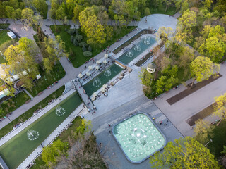 Aerial view on fountains in green spring Shevchenko City Garden. Tourist attraction in renovated city park, recreation in Kharkiv, Ukraine