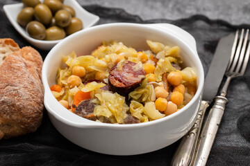Traditional chickpeas dish in casserole in white bowl