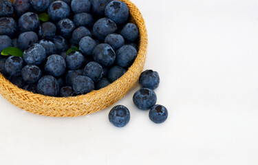 Freshly picked organic blueberries and in a basket on old wooden table.Fresh organic blueberry.Bilberries. Healthy eating,vegan food or diet concept.Summer berries.Selective focus.