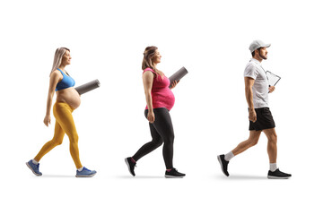Obraz premium Personal fitness trainer walking with two pregnant women