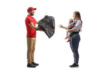 Man delivering clothes from dry cleaners to a mother with a baby