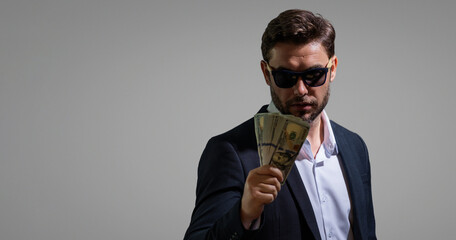 Successful business man counting money. Handsome middle age man holding bunch of 100 dollar banknotes. Guy holding money cash. Profit and financial success. Rich man with dollar cash.