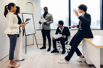 Fototapeta premium Businessman leader in marketing coaching interested business people, giving educational workshop presentation in modern office.