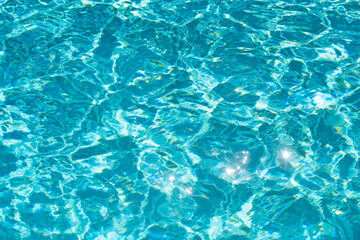 Ripped water in swimming pool. Surface of blue swimming pool, background of water.
