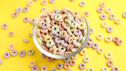 Multicolored corn rings for breakfast on a colored background