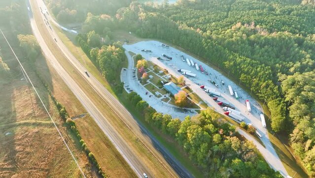 Aerial view of big rest area near busy american freeway with fast moving cars and trucks. Recreational place during interstate travel concept