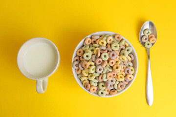 Multicolored corn rings for breakfast on a colored background