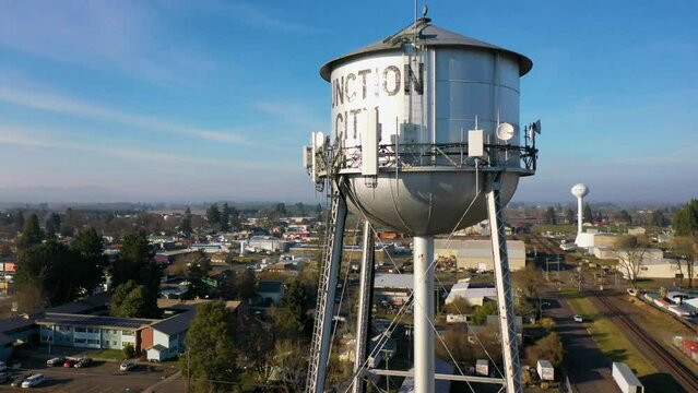 Cinematic Rising Aerial Pan of Junction City, Oregon Old Water Tower to Downtown Junction City and Surrounding Area	
