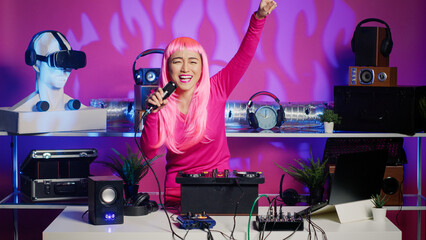 Smiling performer dancing and singing in nightclub, mixing eletronic sound with techno using professional mixer. Dj artist playing remix using audio equipment, performing at festival