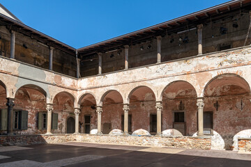 Fototapeta na wymiar The two story cloister courtyard area of the 14th century Carmine Monastery in the historic Citta Alta upper town district of Bergamo, Italy.