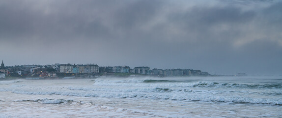 Portrush, Northern Ireland at dusk between a stormy sky and sea